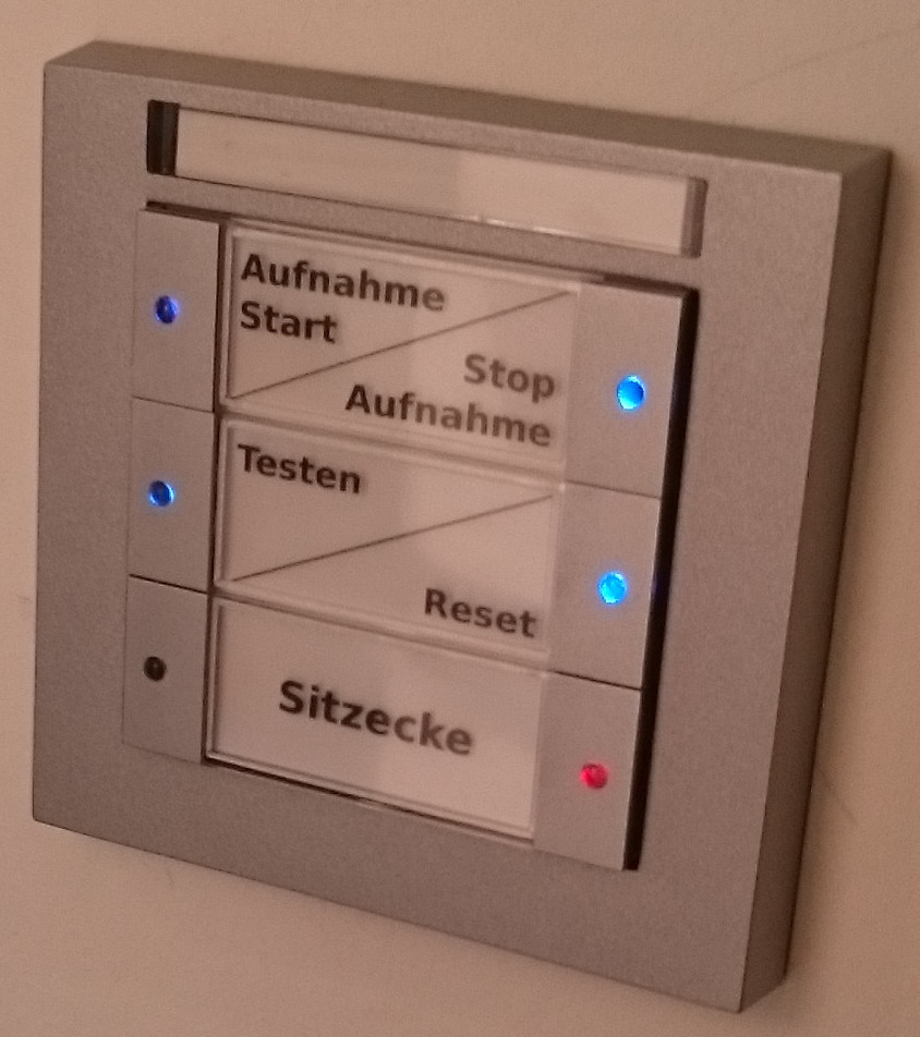 Buttons mounted in the living room next to the sports door