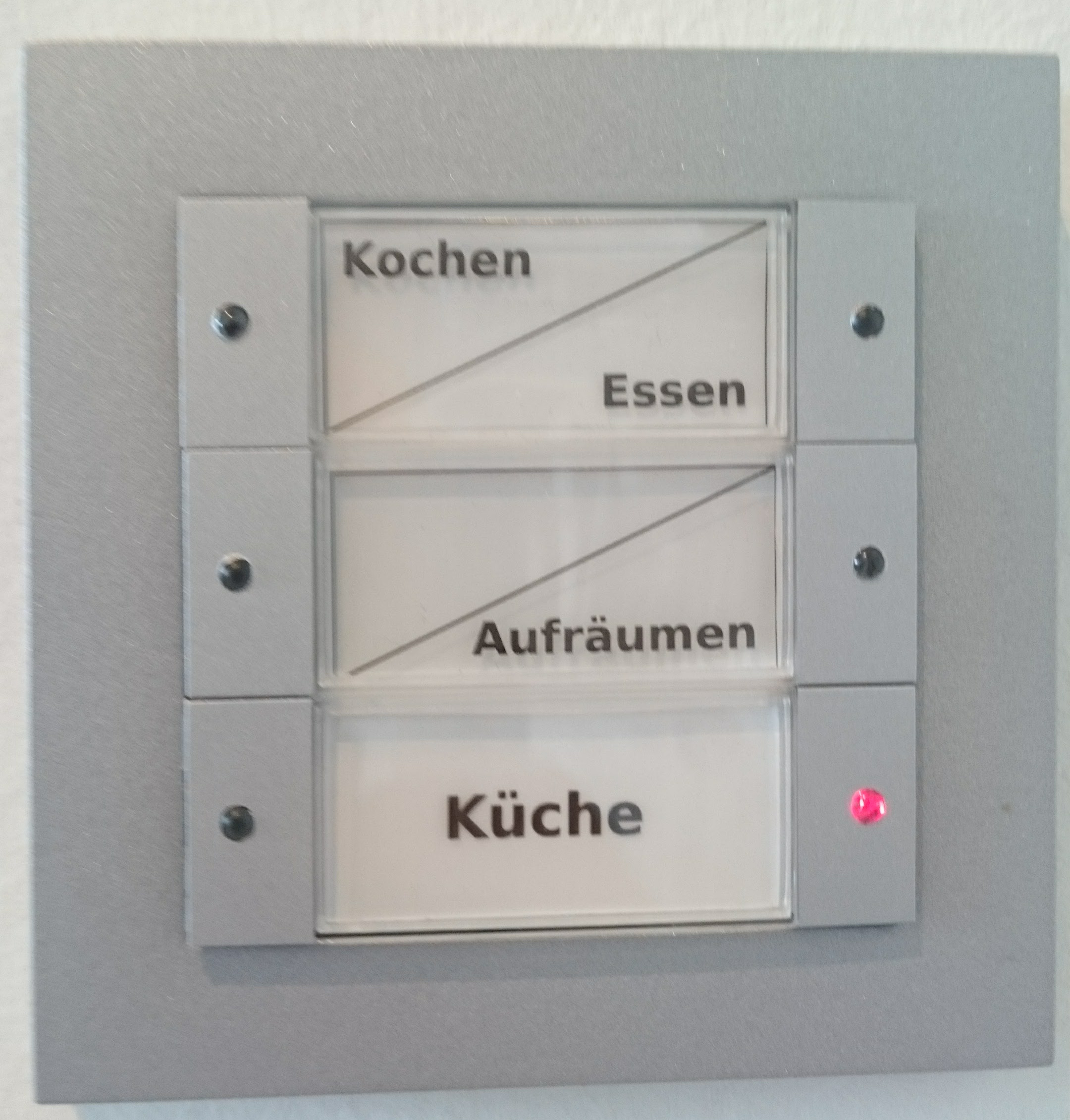 Buttons mounted in the kitchen next to the fridge